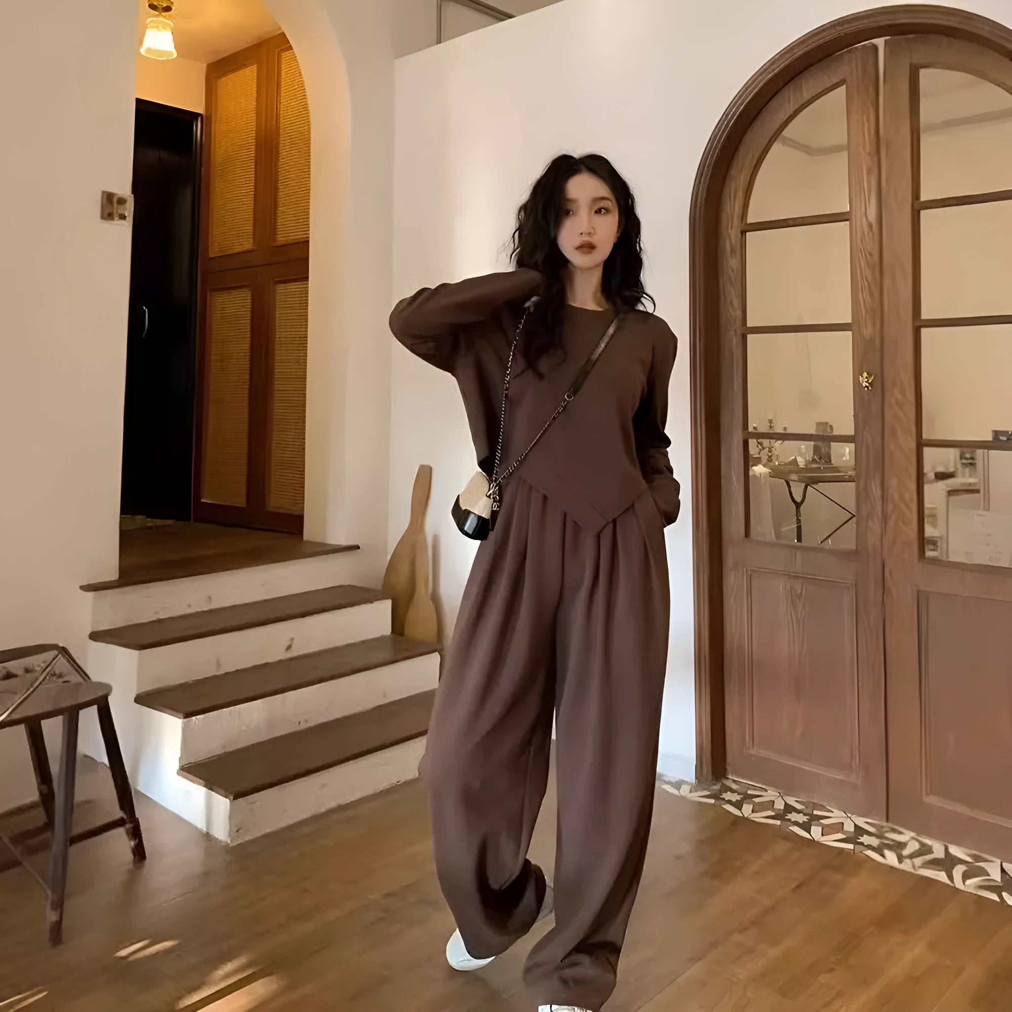 Women's khaki loose-fit casual sports suit with long sleeve top and trousers on a hanger.