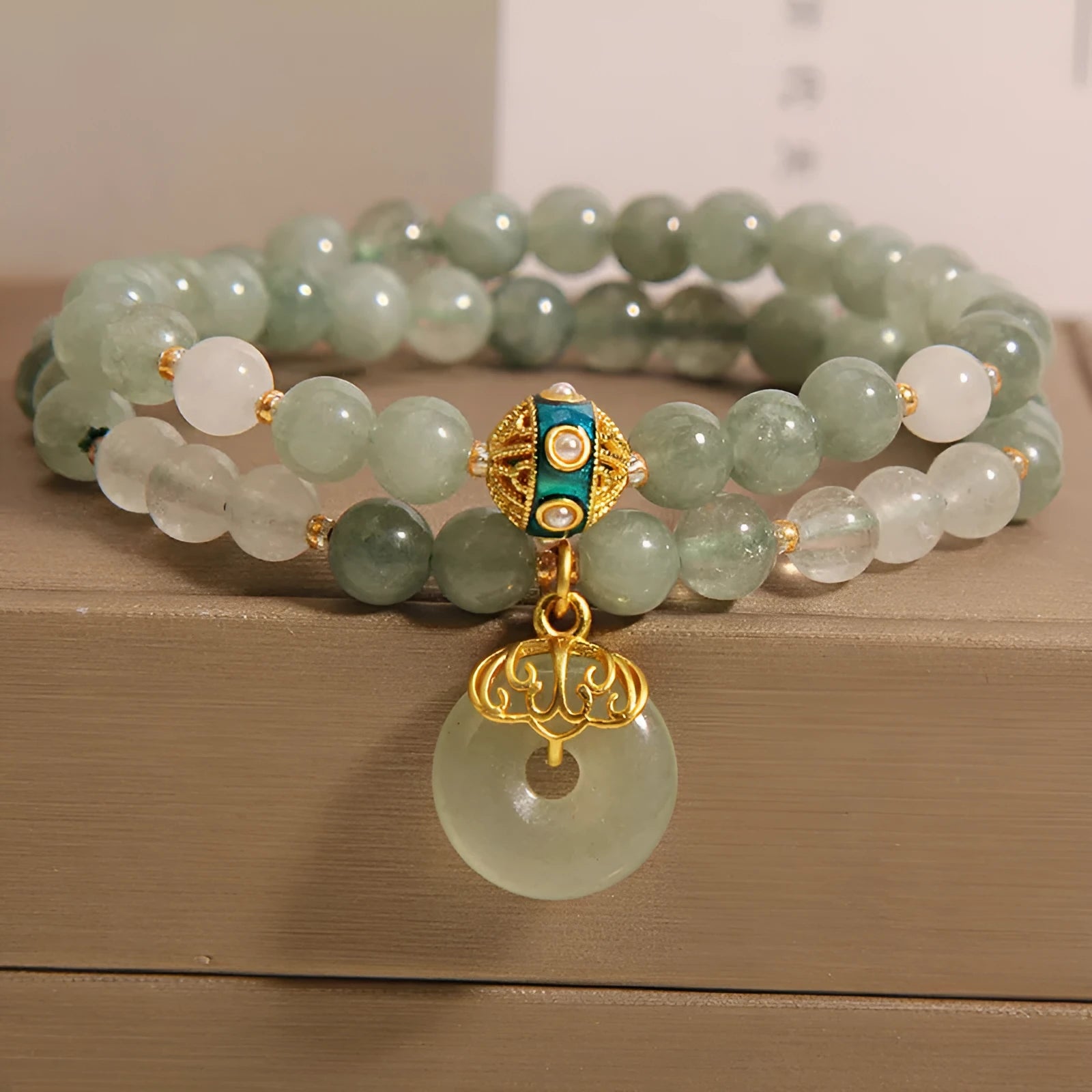 Women's double-layer aventurine jade bracelet in oil green with a safety buckle and rhinestone details.
