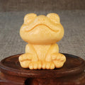 Solid bamboo carving ornament of a smiling cartoon frog, 5 cm tall.