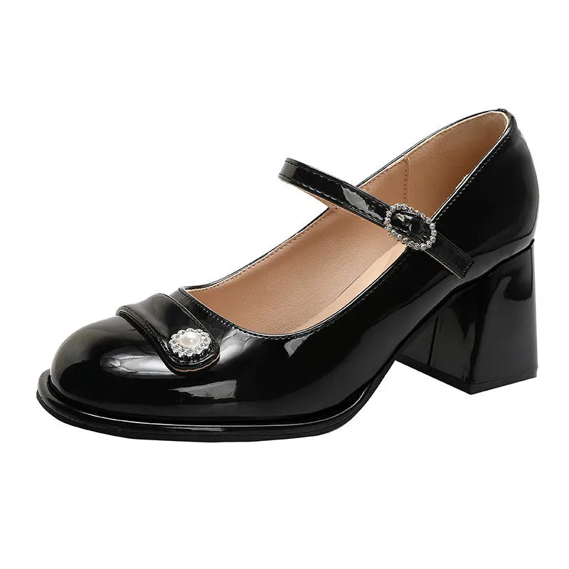 Women's black patent leather chunky heel round toe shoes with buckle fastening.