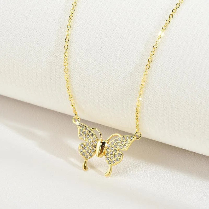 Women's magnetic snap butterfly clavicle chain necklace in gold finish showing twisted chain detail