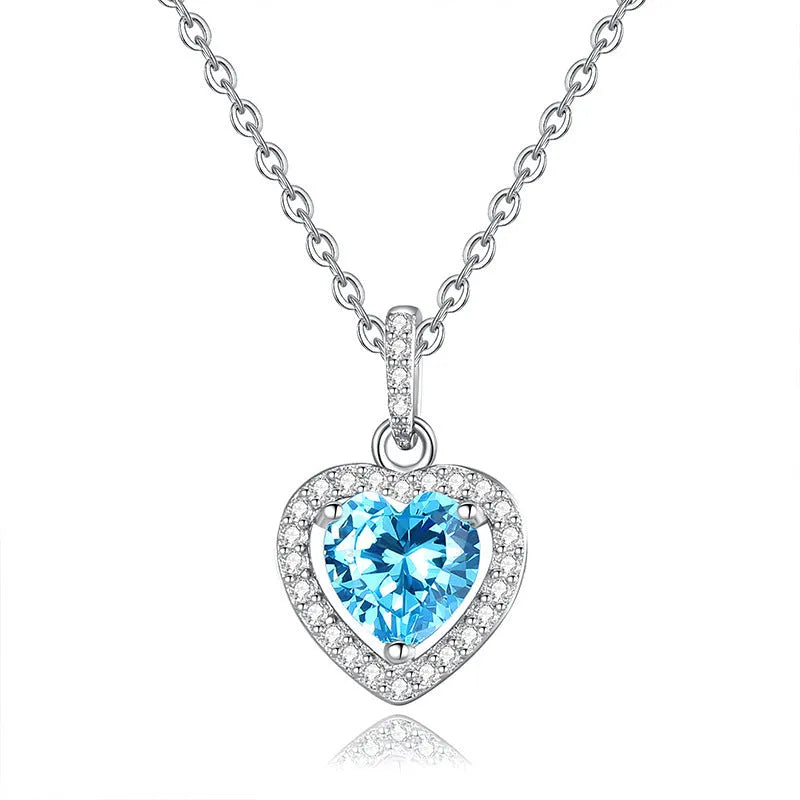 Sterling silver heart necklace with a natural amethyst gemstone on a cross chain.
