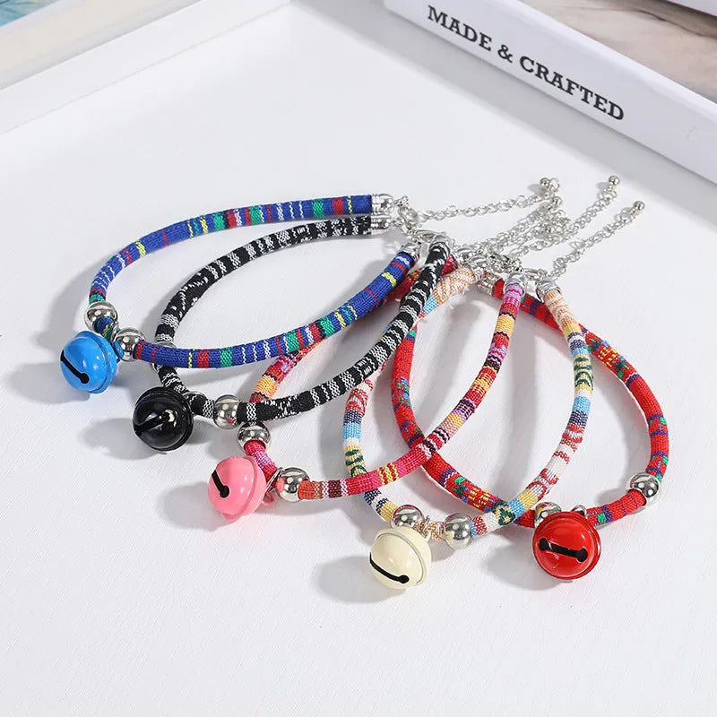 Adjustable ethnic pattern pet collar with a bell, shown in various colours for cats and small dogs.