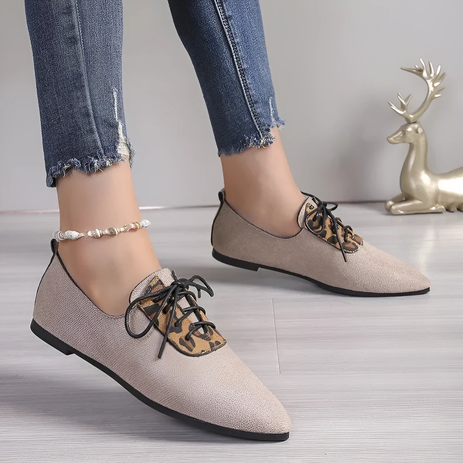 Beige leopard print women's pumps with a pointed toe, shown in a plus size.