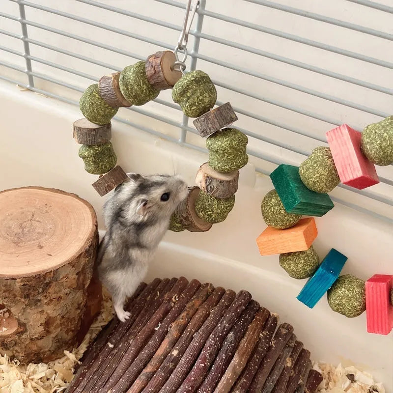 Hamster toy with applewood chew rod and decorative straw ball rings for small animal enrichment