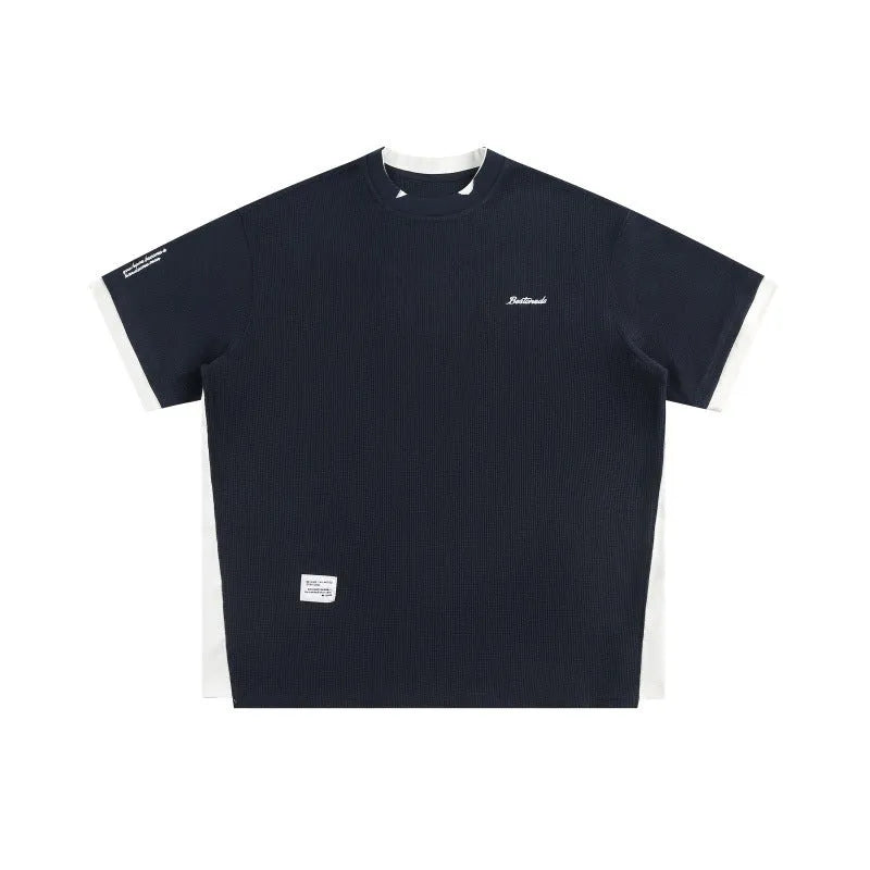 Retro alphabet embroidered waffle knit T-shirt in loose fit, shown in navy blue.