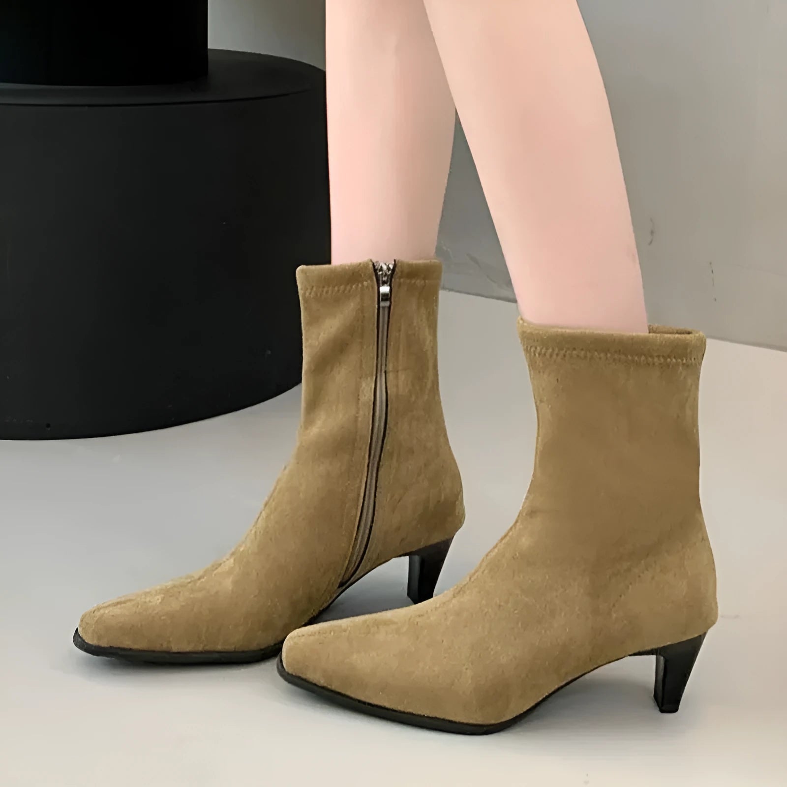 Brown women's square toe ankle boots with a side zip and mid kitten heel on a waterproof platform sole.
