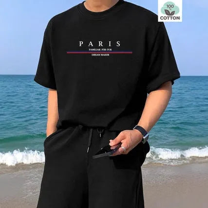 Man wearing a loose-fit short-sleeved t-shirt with a large letter print on the chest in a solid colour.