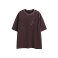 Loose retro-style short-sleeve cotton t-shirt with embroidered detailing in black or purple colour.