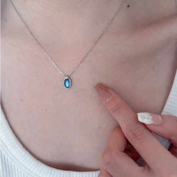 Navy blue geometric water drop necklace on adjustable cross chain, platinum-colour finish