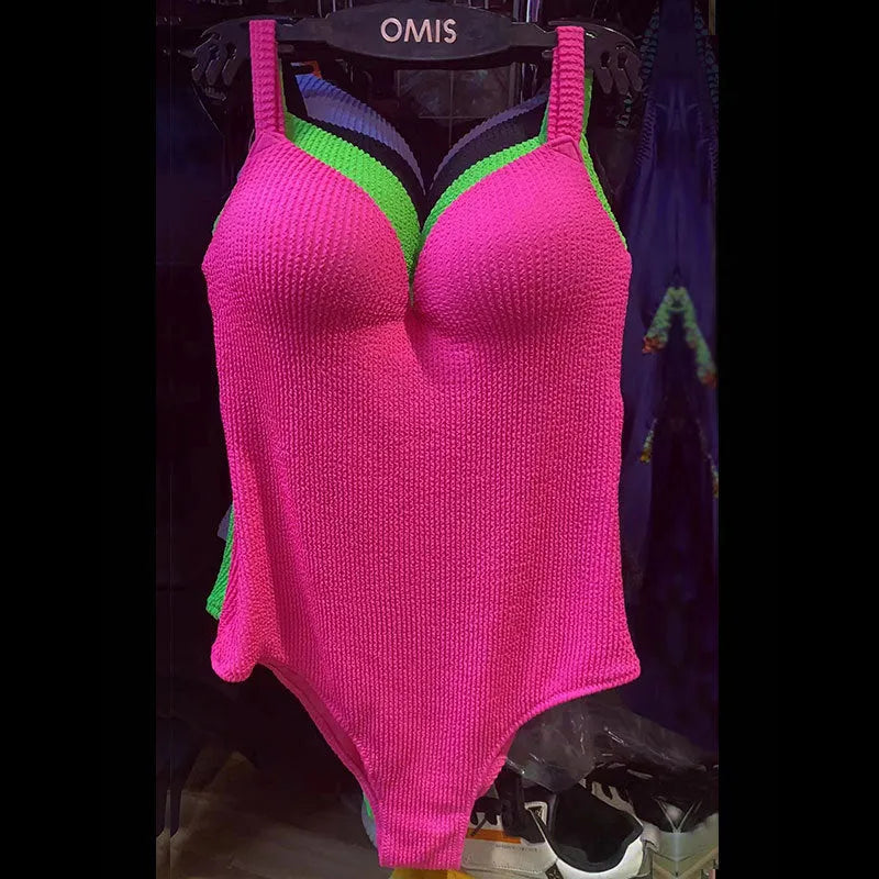 Women's black one-piece swimsuit with a sunken white stripe pattern across the front, sleeveless design.