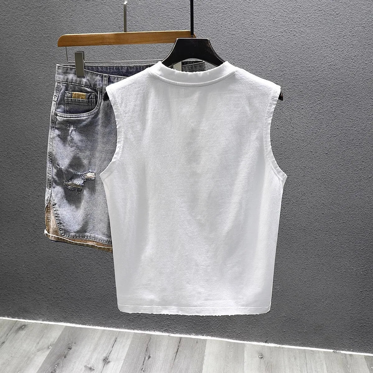 Solid colour loose cotton sleeveless t-shirt on a hanger in white or black