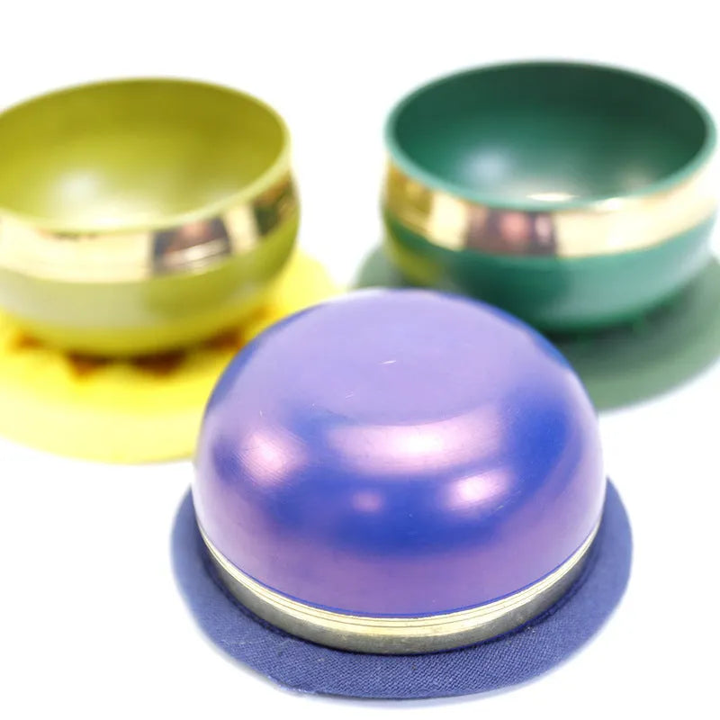 Handmade Himalayan singing bowl percussion instrument in seven colours for yoga meditation