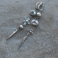 Geometric antique silver earrings with rhinestone accents and XINGX pendant design