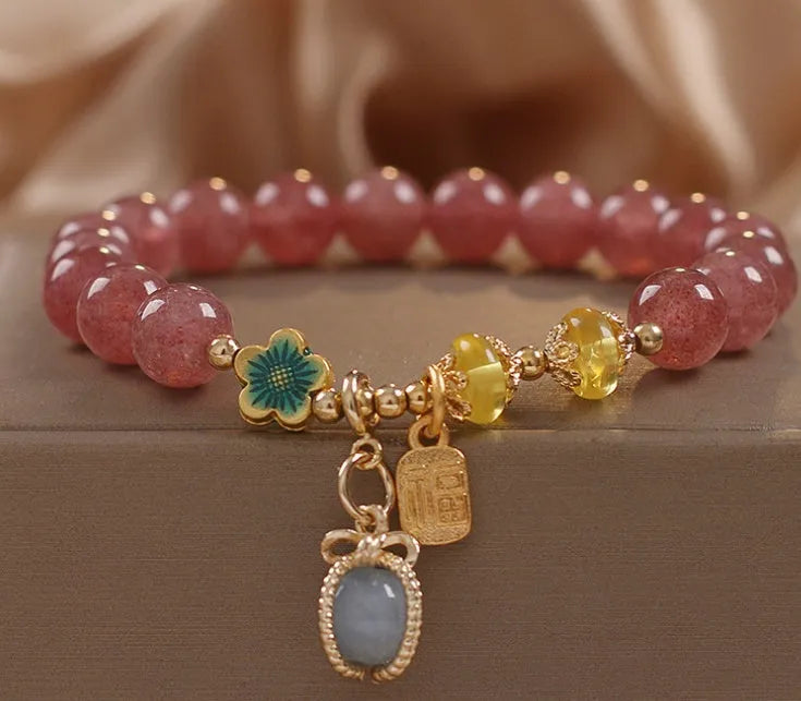 Red women's bracelet with natural strawberry quartz beads and rhinestone details on alloy setting