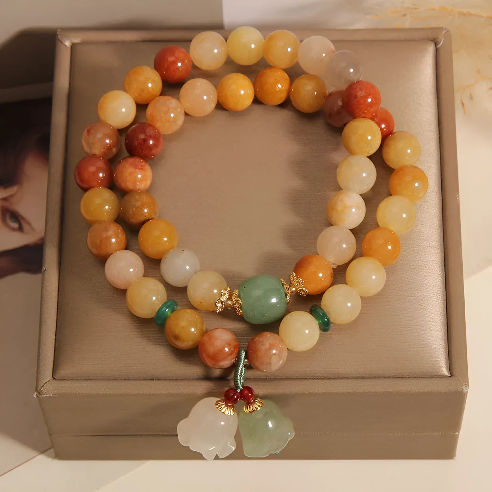 Natural green jade multi-layer wrap bracelet for women with a silver orchid pendant charm.