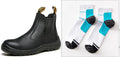 Black high-top leather safety work boots with anti-piercing sole on a grey industrial background