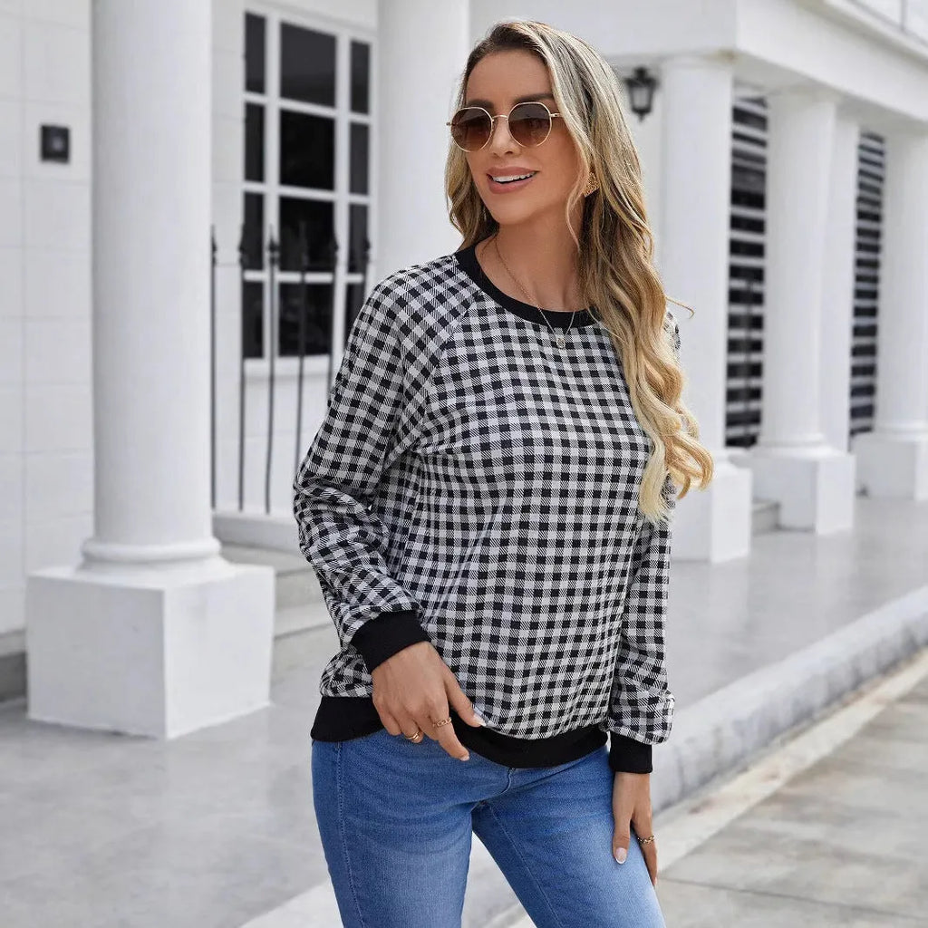 Black Japanese plaid pattern long sleeve pullover sweater on a hanger.