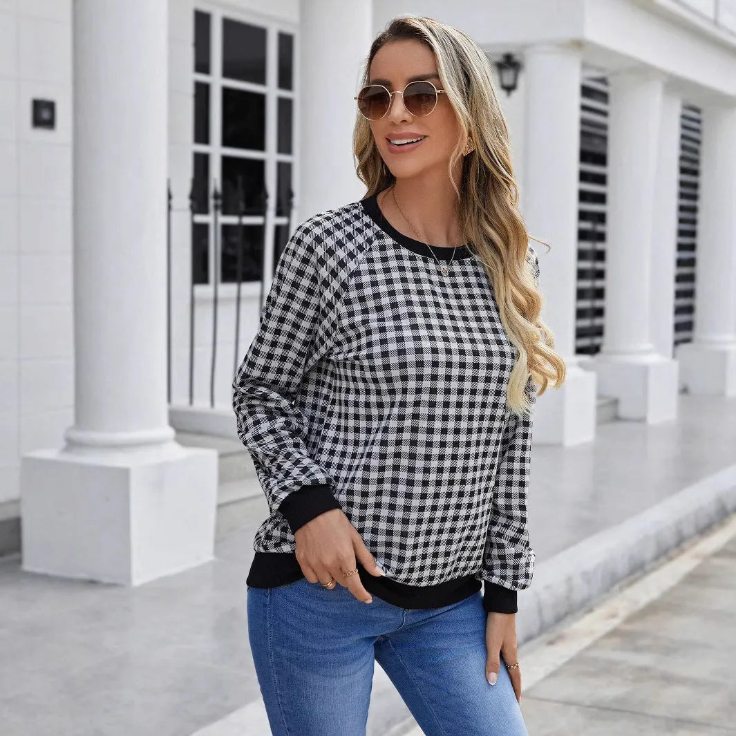 Black Japanese plaid pattern long sleeve pullover sweater on a hanger.