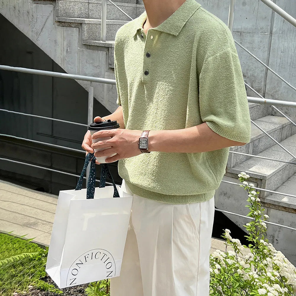 Man wearing a caramel-coloured retro knitted polo shirt with short sleeves and an asymmetric design detail.