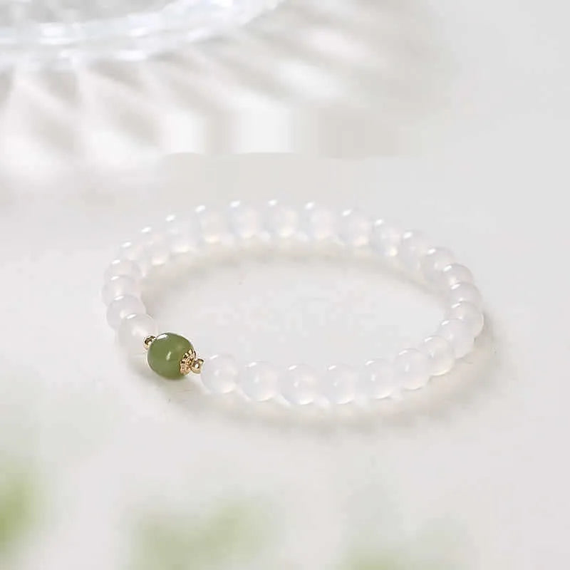 Handmade white agate and crystal bracelet with cinnabar inlay, showing 6mm or 8mm bead size.