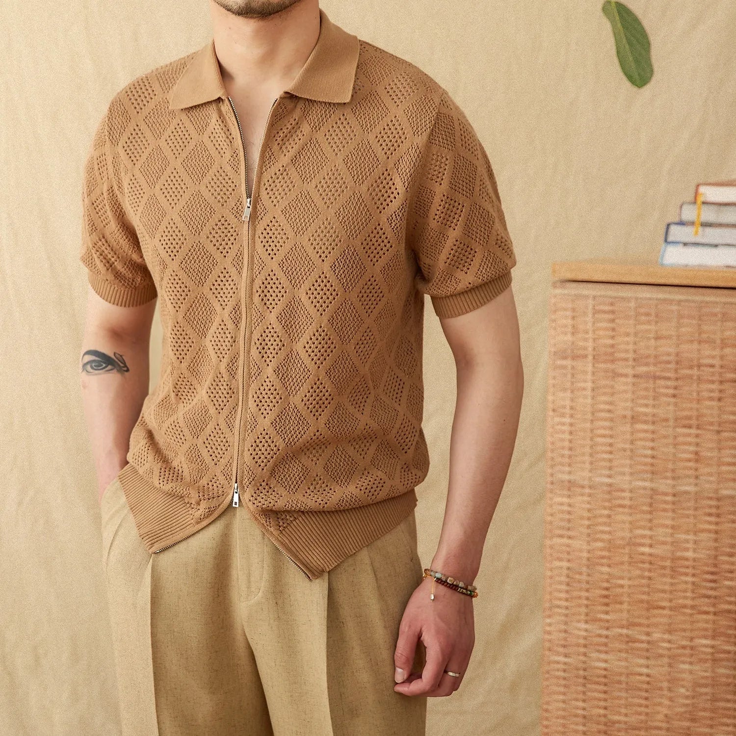 Front view of a white cotton cardigan with a zipper and lapel collar.