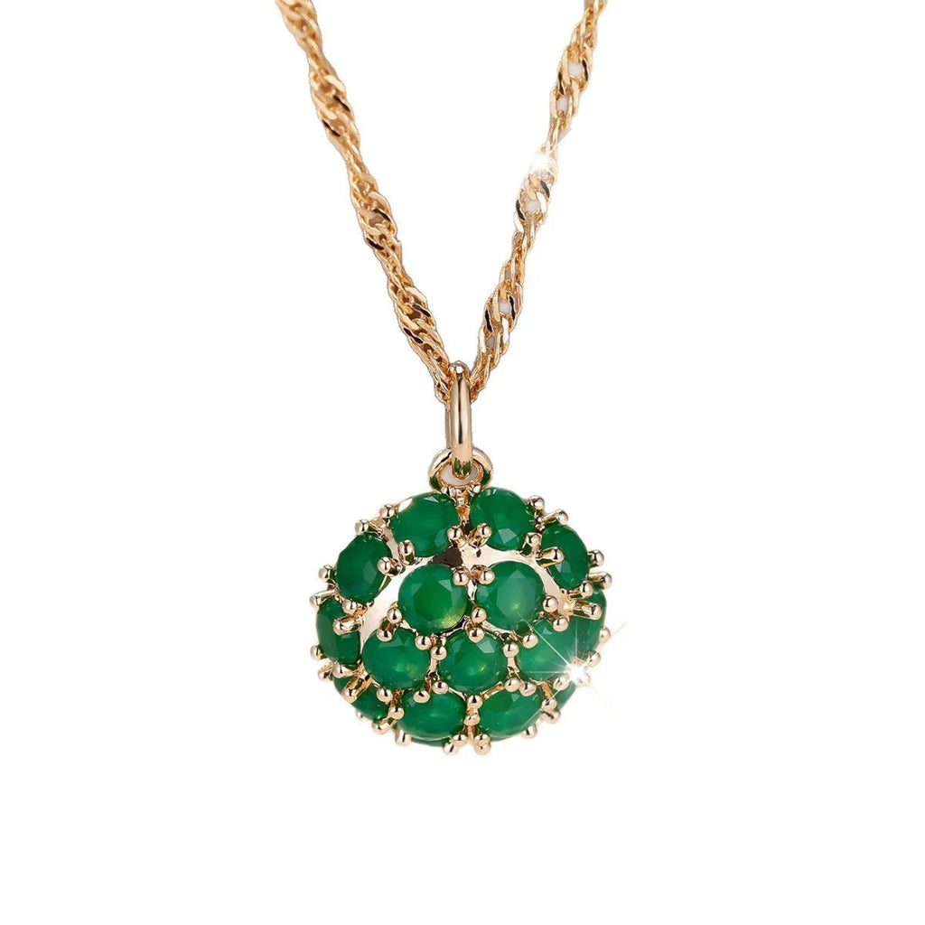 Round emerald and diamond pendant on an adjustable champagne gold electroplated copper chain necklace.