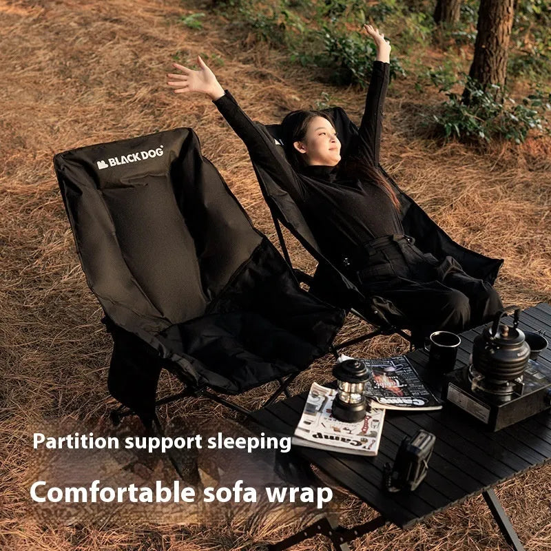 Night Black Oxford cloth folding moon chair in a reclined position on grass.