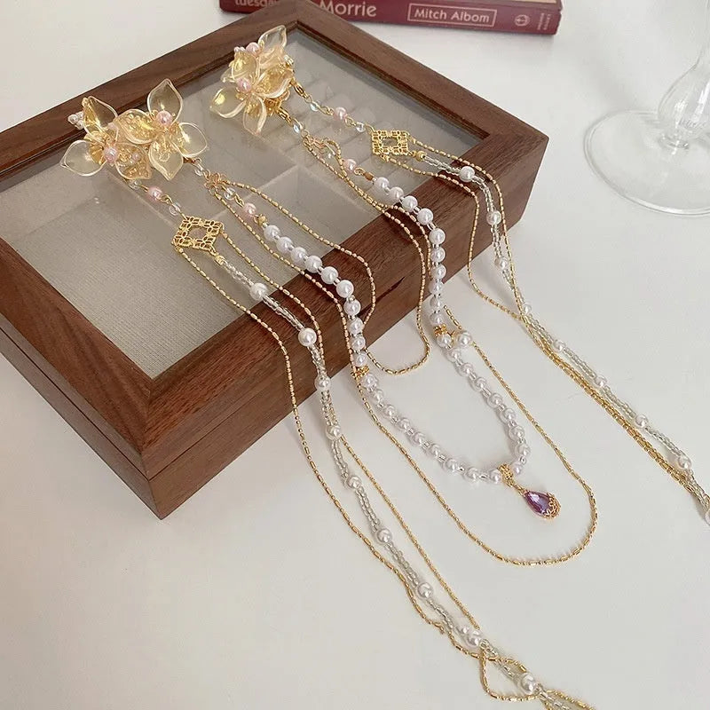 Gold women's hairpin with pearl diamond flower decoration and long acrylic tassel.