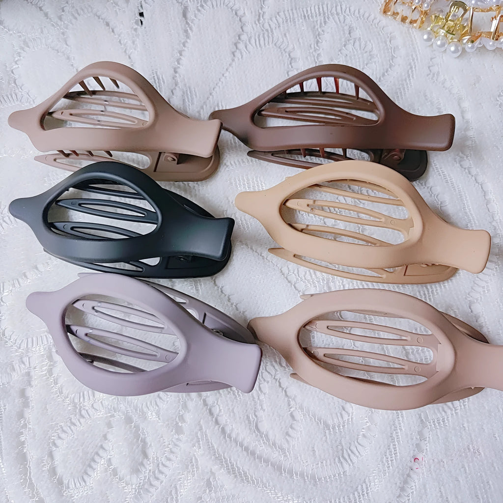 Set of six nude-coloured plastic women's hair clips with frosted grip and pointed toe design