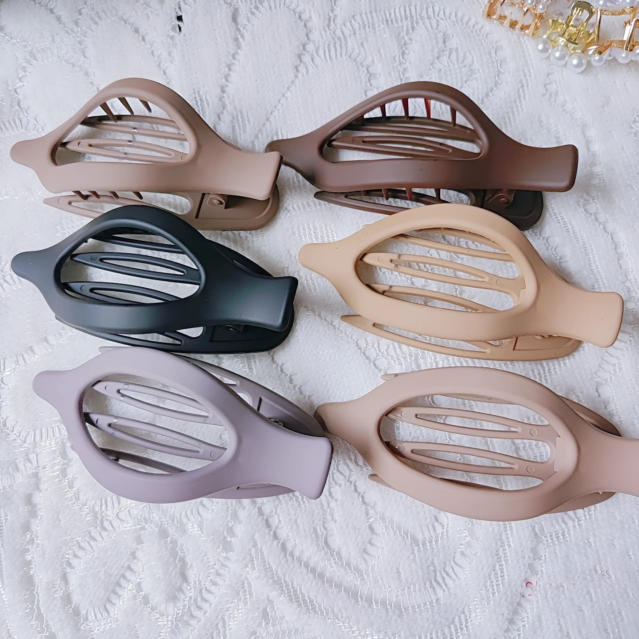 Set of six nude-coloured plastic women's hair clips with frosted grip and pointed toe design