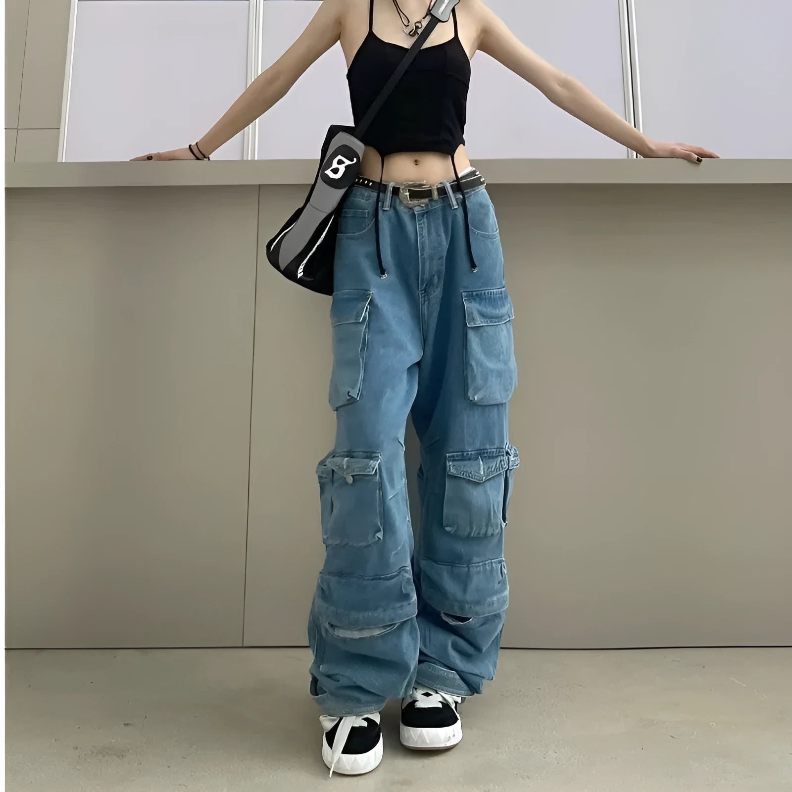 Blue and black tie-dyed women's high-waist wide-leg jeans with multiple pockets.