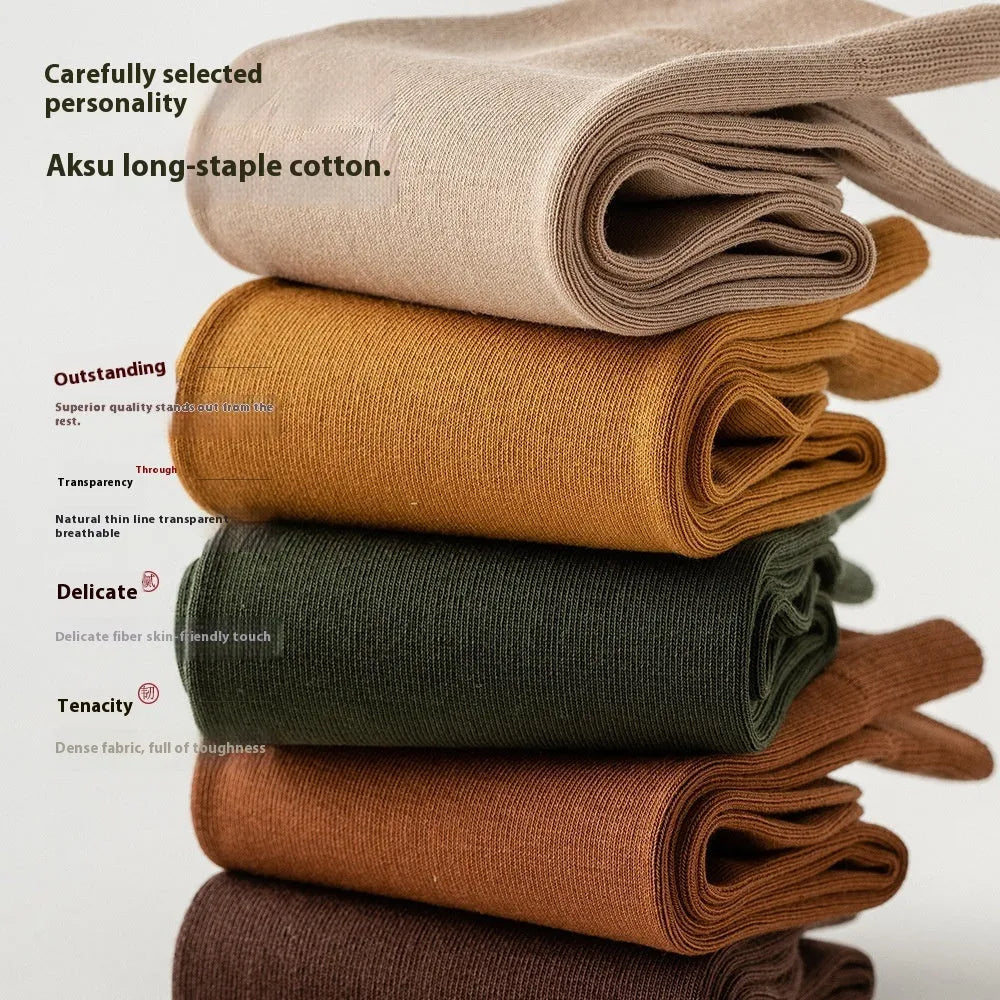 A pair of men's solid colour mid-calf socks made from combed cotton, shown in a light grey hue.