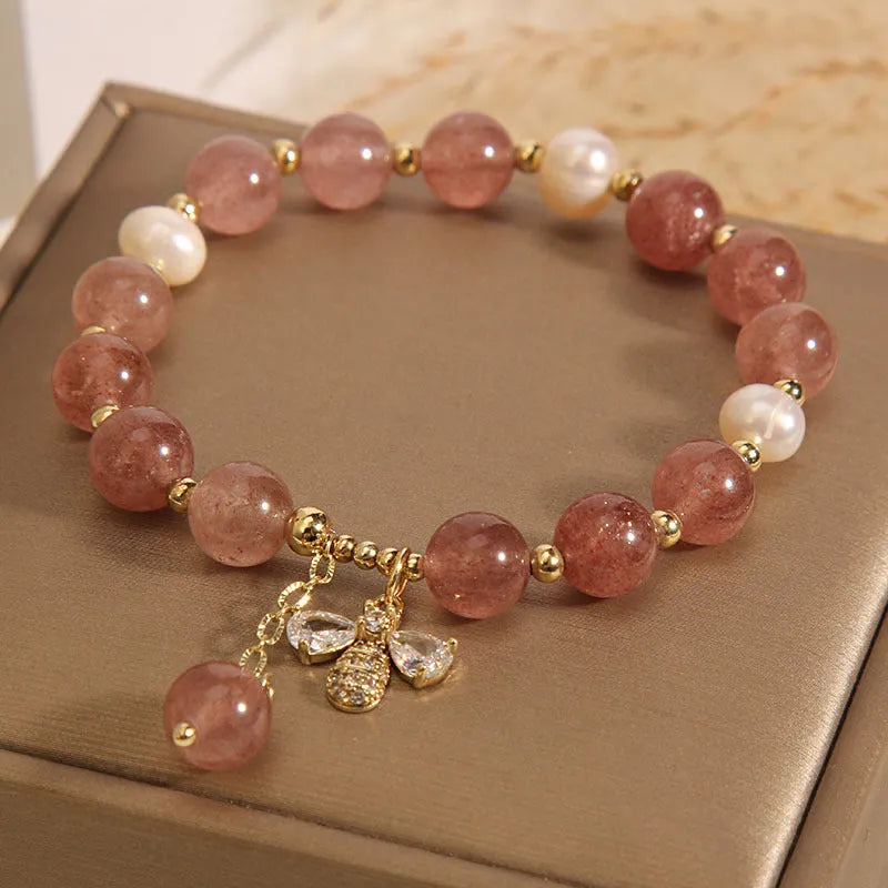 Women's bracelet with freshwater pearls, strawberry quartz beads, zircon accents, and an alloy clasp.