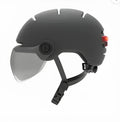 Cycling helmet with integrated LED brake and tail lights showing PC shell construction