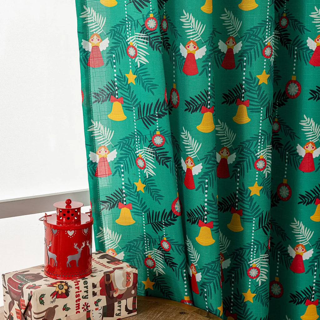 Green festive curtain with printed cartoon snowman and angel pattern.