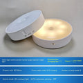 Small white circular USB rechargeable LED motion sensing night light with adhesive backing.