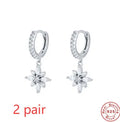 A pair of women's S925 sterling silver snowflake pendant earrings with a geometric design, available in yellow gold or white gold colour finishes.