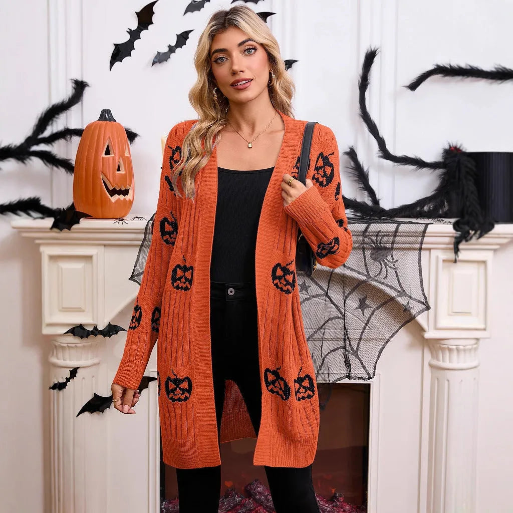 Women's black Halloween cardigan with orange pumpkin head jacquard pattern, shown as a straight-cut medium-length knit.