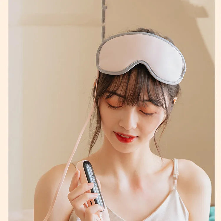 Pink and green portable heated eye mask with USB charging and vibration features for home and office use