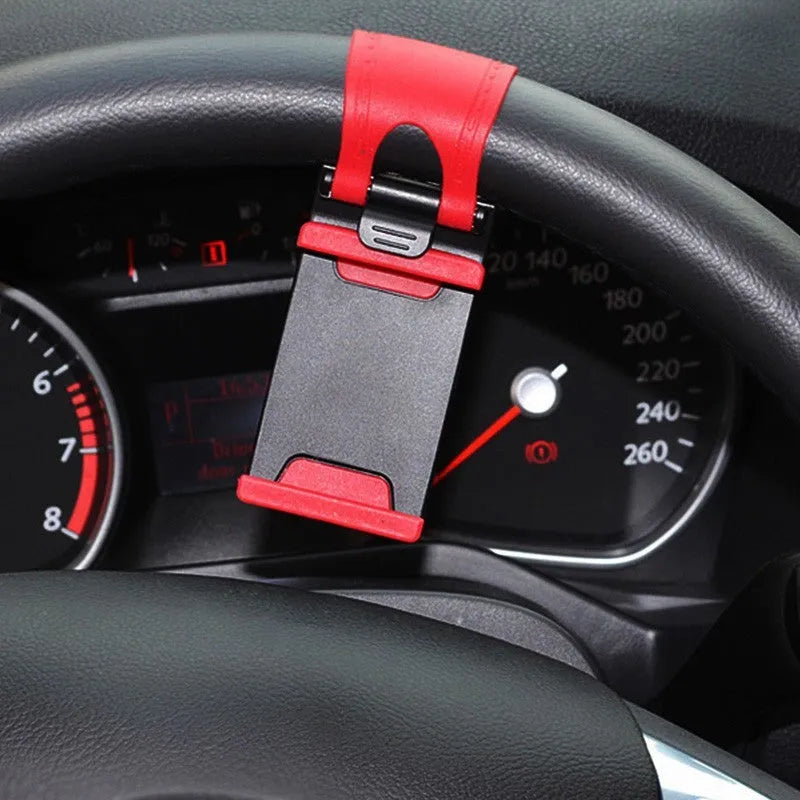 Black universal clip mount holding a mobile phone on a car steering wheel