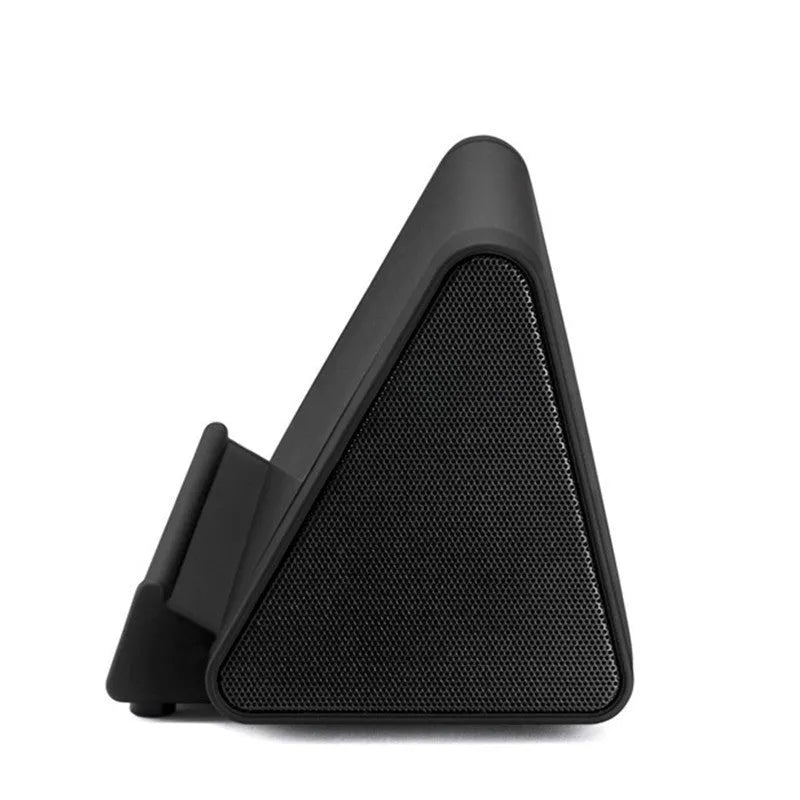Black and white wireless mini Bluetooth speaker with charging cable.