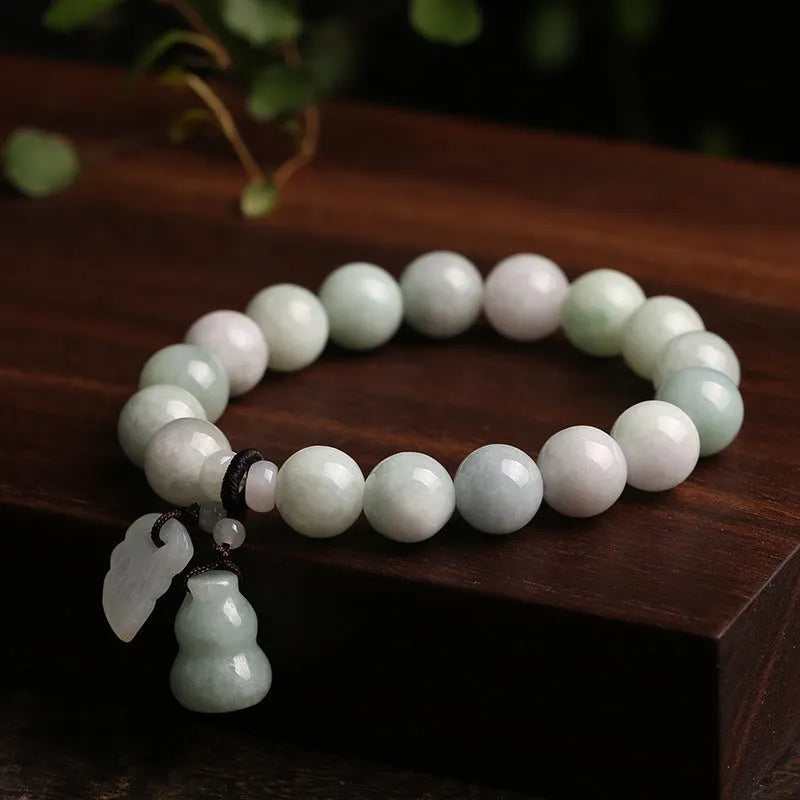 Jade hanging charm bracelet with geometric design and Buddhist symbolic pendant