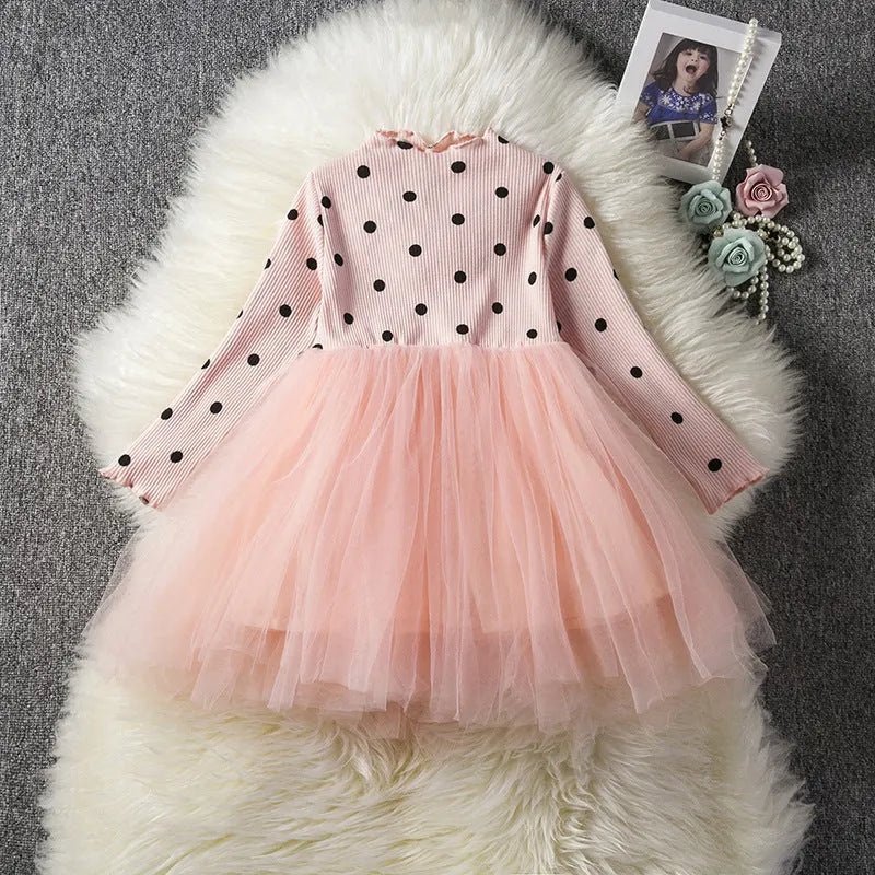 Baby girl wearing a long sleeve black tutu dress with lace detail, suitable for a party or casual wear.