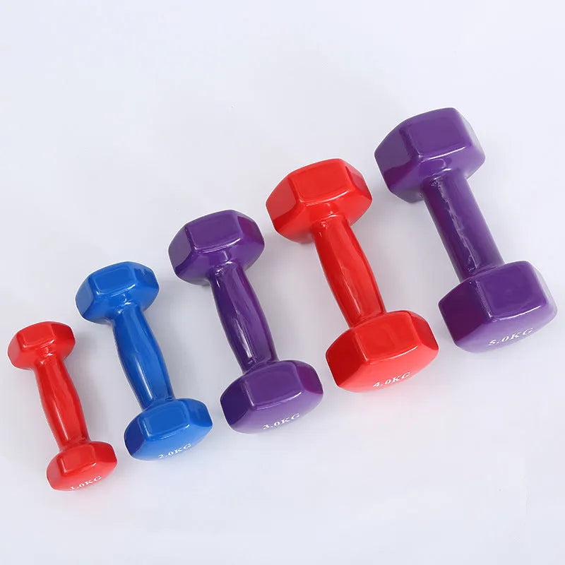 Bright coloured plastic-coated fitness dumbbell showing glossy finish on a home gym floor.