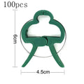 Green plastic plant fixing clips, 10 large and 10 small, for securing climbing plants like tomatoes and cucumbers.