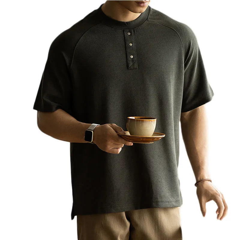 Casual loose-fitting grey pullover top with raglan sleeves and a textured terry fabric.