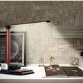Black or white X-1 4-in-1 LED desk lamp showing wireless charging surface and USB port