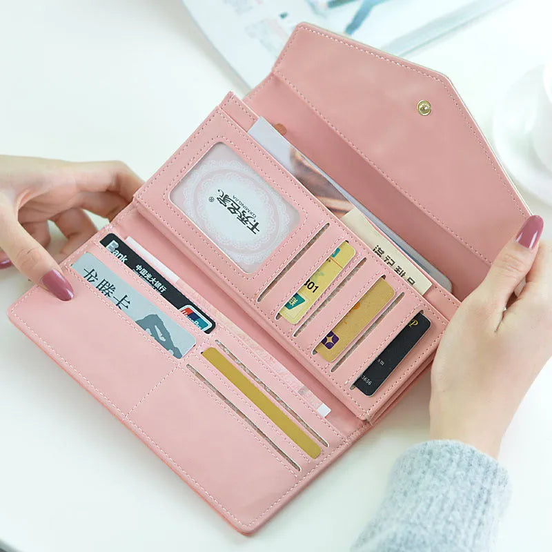 Women's three-fold PU leather wallet with buckle closure and metal clip in five colour options