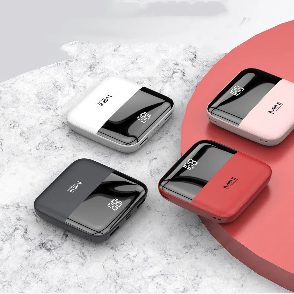 Black 10000mAh portable power bank with digital display showing battery percentage and dual USB ports.
